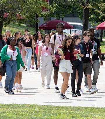 Cluster of students walking together outside at orientation